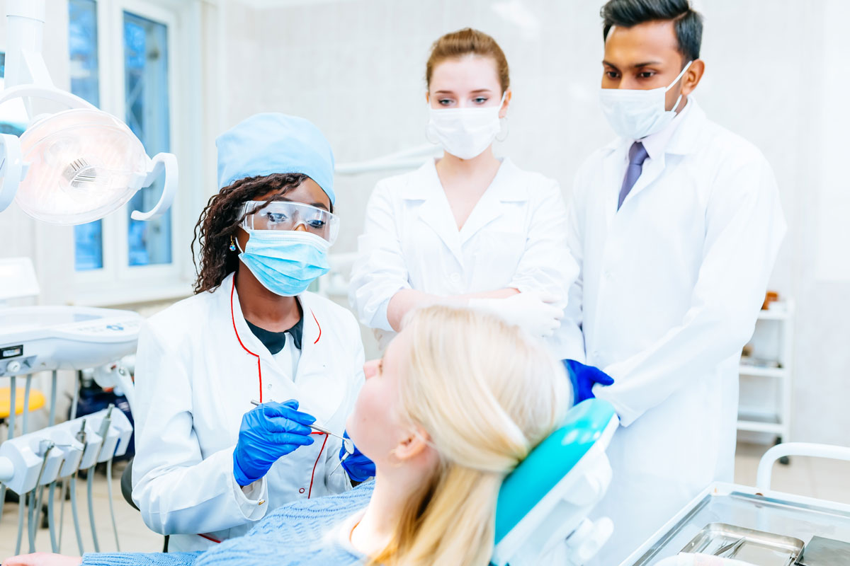 multiracial-dental-team-with-patient-in-dental-cli-2023-11-27-05-35-08-utc_1200px